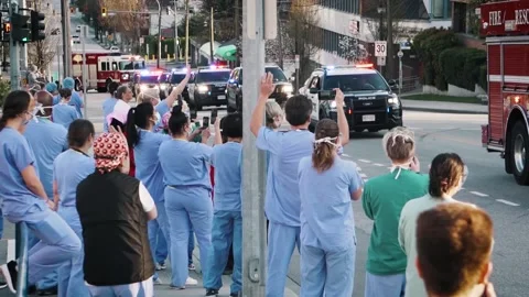 Nurses Doctors Waving in Scrubs During Covid-19 Coronavirus Pandemic Видео 135493060