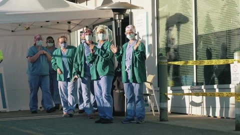 Nurses Doctors Waving in Scrubs During Covid-19 Coronavirus Pandemic Видео 135493088