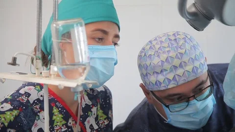 Nurses during surgery. close-up. protective mask. dropper. defocused faces Stock Footage 99198053