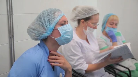 Nurses during surgery. close-up. protective mask. note journal Stock-Footage 99198705