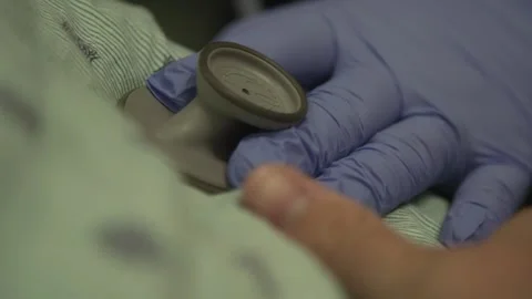 Nurse's hand wearing glove checking heartbeat Stock Footage 146278481