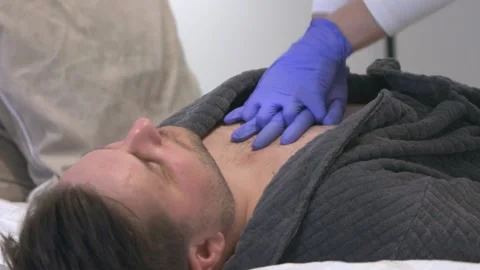 Nurse's Hands In Gloves Pumping Unconscious Man's Chest. First Aid Stock Footage 224490805