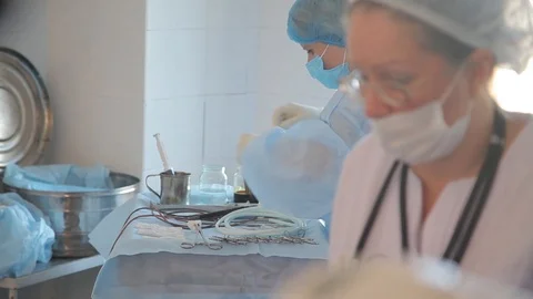 Nurses in a large operating room prepare scalpels and medical instruments Vídeos de archivo 99193829