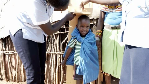 Nurses measuring the height of child, Kenya, Africa. Stock-Footage 88867720
