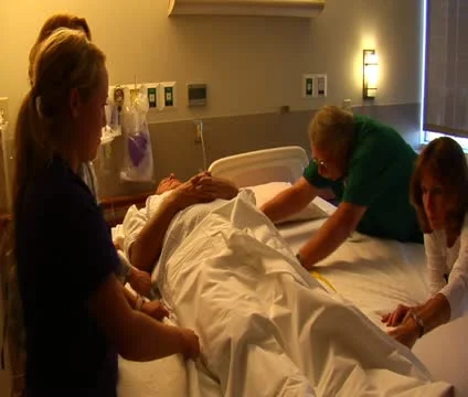 Nurses moving patient from one bed to another Stock Footage 21597953