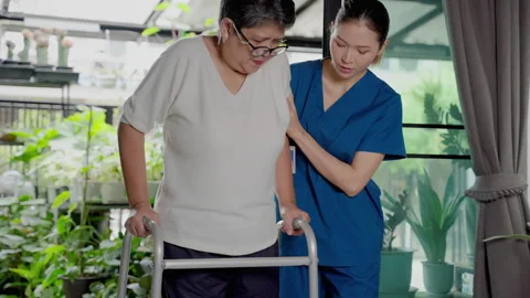 Nurses in nursing homes being care for the elderly woman help to walk by walke Stock Footage 162052383