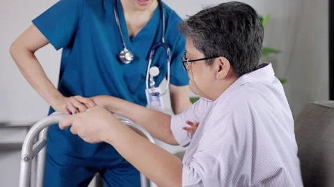Nurses in nursing homes being care for the elderly woman help to walk by walker Stock Footage 165960210
