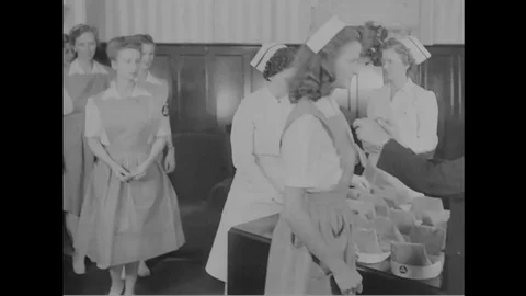 Nurses pledge and receive pin and hat during American Red Cross training - 1940 Video stock 103599167