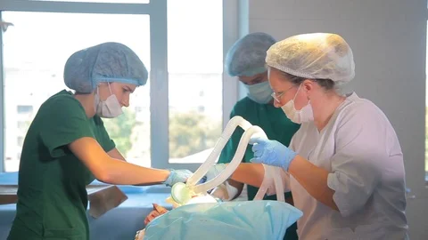Nurses prepare patient for the operation. Nurses connect patient to AVL. Video stock 99221241