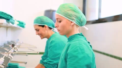 Nurses putting hands and forearms under water Stock Footage 11703756