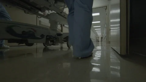 Nurses Run Alongside a Gurney Down a Hospital Hallway HD Video Video stock 90346211