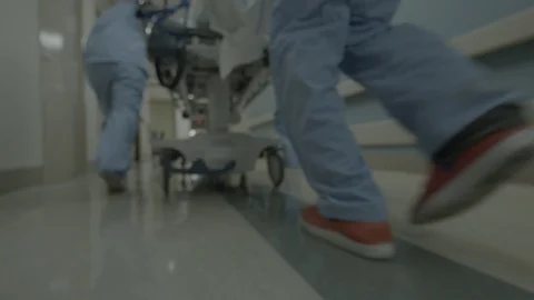 Nurses Rush a Gurney Down a Hospital Hallway HD Video Stock Footage