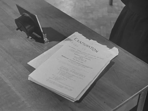 Nurses sitting in desks, getting examination papers and writing test, UK 1951 Stock Footage 134030173