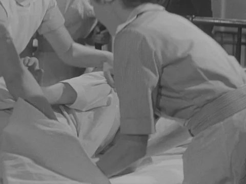 Nurses in training working together in classroom and listening to teacher, 1951 Stock Footage 134029108