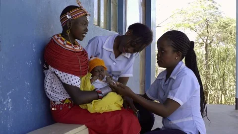Nurses undertaking an examination, and immunisation of baby, Kenya, Africa. Stock Footage 76577672