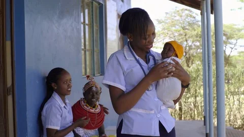 Nurses undertaking an examination, and immunisation of baby, Kenya, Africa. Stock Footage 76577743