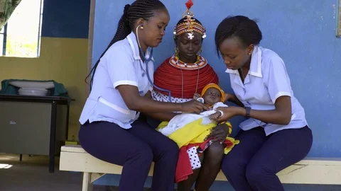 Nurses undertaking an examination, and immunisation of baby, Kenya, Africa. Stock Footage 76578748
