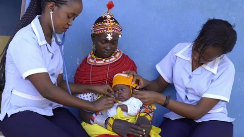 Nurses undertaking an examination, and immunisation of baby, Kenya, Africa. Stock Footage 76578926