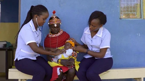 Nurses undertaking an examination, and immunisation of baby, Kenya, Africa. Stock Footage 76579304