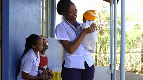 Nurses undertaking an examination, and immunisation of baby, Kenya, Africa. Stock Footage 76580282