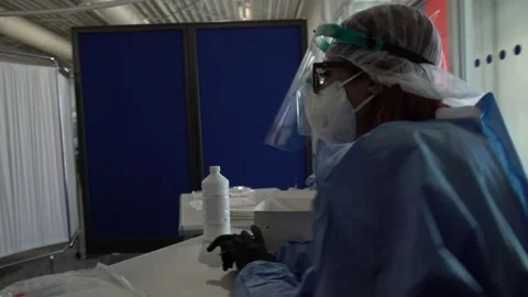 Nurses wait to perform COVID-19 tests to tourists at the Athens Airport  Stock Footage 142881297