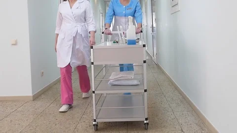 Nurses wheel a cart Stock Footage 121985779