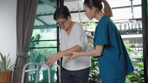 Nursing Home is helping elderly people learn to walk using a walker. Stock Footage 276573351