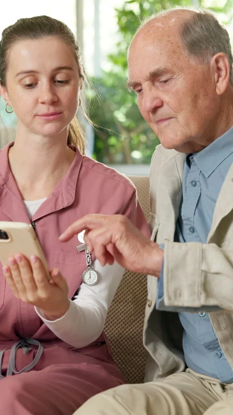 Nursing home, old man and nurse with phone, talk and explaining medical schedule 스톡 동영상 341074048
