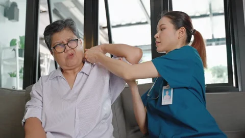 Nursing home is performing arm physical therapy on an elderly woman. Stock Footage 276573219