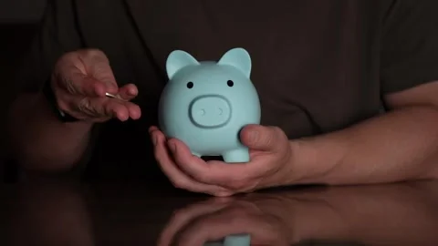 Nurturing a Future Nest Egg in a Charming Blue Piggy Bank Stock Footage 342228949