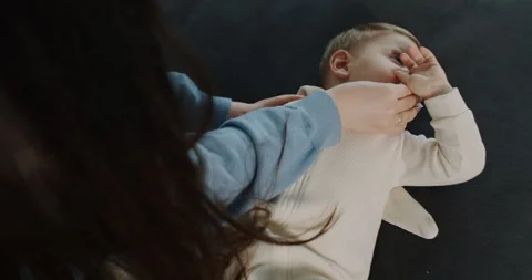 A nurturing mother shows her dedication to her babys wellbeing Video stock 307303595