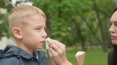 Nurturing mother softly provides solace and serenity to her child outside Stock Footage 333100197