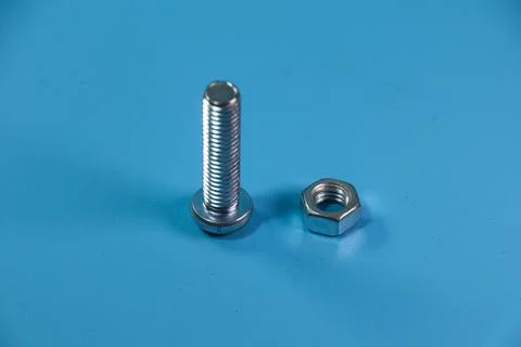 Nut and bolt in close up on blue background Stock Photos