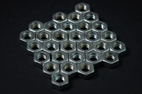 Nut bolts on a black background. threaded fastener.  Stock Photos