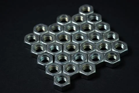 Nut bolts on a black background. threaded fastener.  Stock Photos