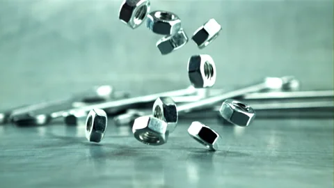 Nut bolts fall on the table. Filmed is slow motion 1000 frames per second. 스톡 동영상 166611360