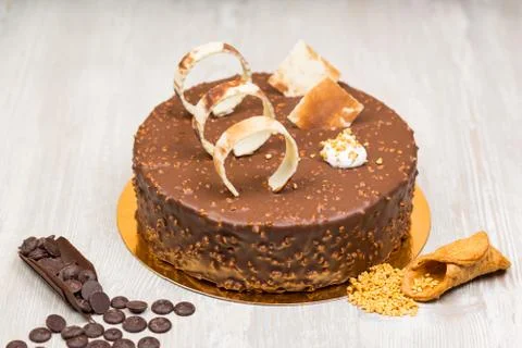Nut chocolate cake with biscuits and nuts on the table Stock Photos