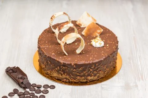 Nut chocolate cake with biscuits rings on the table Foto stock