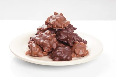 Nut chocolates on plate Stock Photos