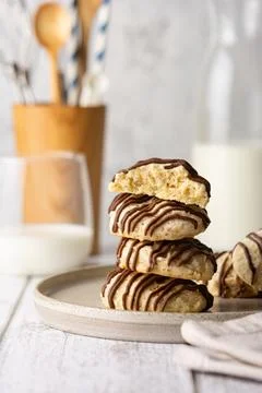 Nut cookies with chocolate icing. A stack of crispy biscuits on a plate, with Stock Photos