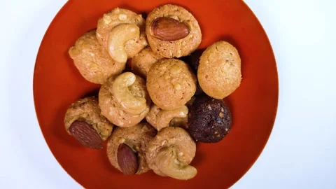 Nut cookies on a plate rotating Stock Footage 301413602