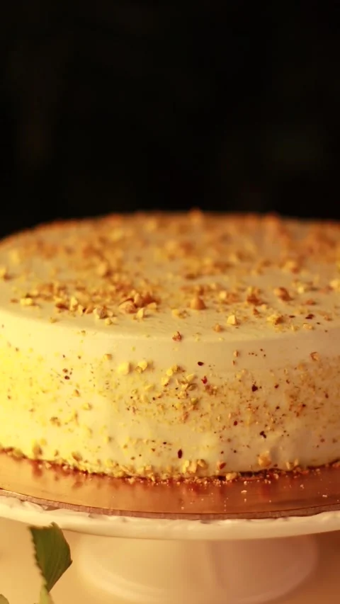 Nut Cream Cake on a Cake Turntable in a Cozy Atmosphere with Yellow Roses Stock Footage 241324241