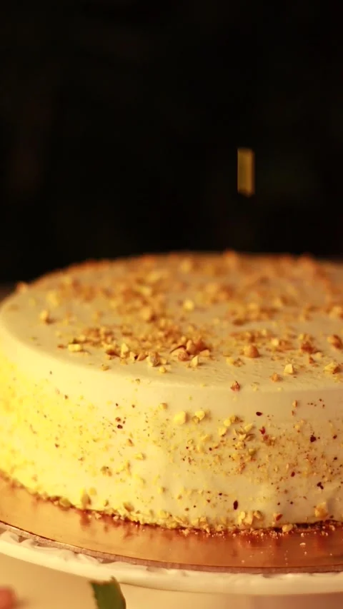 Nut Cream Cake on a Cake Turntable in a Cozy Atmosphere with Yellow Roses Stock Footage 241324245