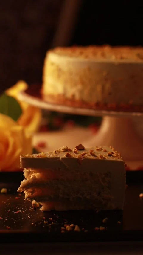 Nut Cream Cake on a Cake Turntable and a Slice of Cake in a Cozy Atmosphere Video stock 241324250