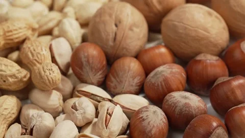 Nut mix, close-up of peanuts, walnuts, hazelnuts and pistachios, rotating, Stock Footage 334012179