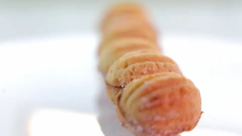 The nut-shaped cookie sprinkled with sweet powder rotates on a 360 platform Stock Footage 240981886