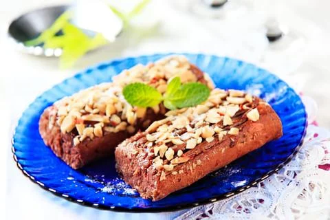 Nut-topped baked bread on blue plate Stock Photos