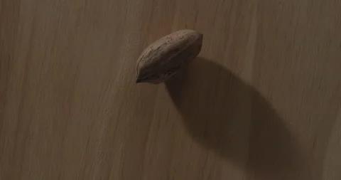 Nut on wood table Stock Footage 146424420
