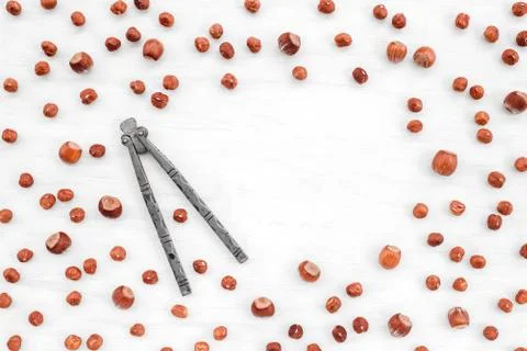 Nutcracker and hazelnuts on white background with copy space Foto stock