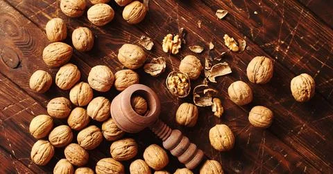 Nutcracker and nuts lying on table From above shot of wooden nutcracker an... Stock Photos